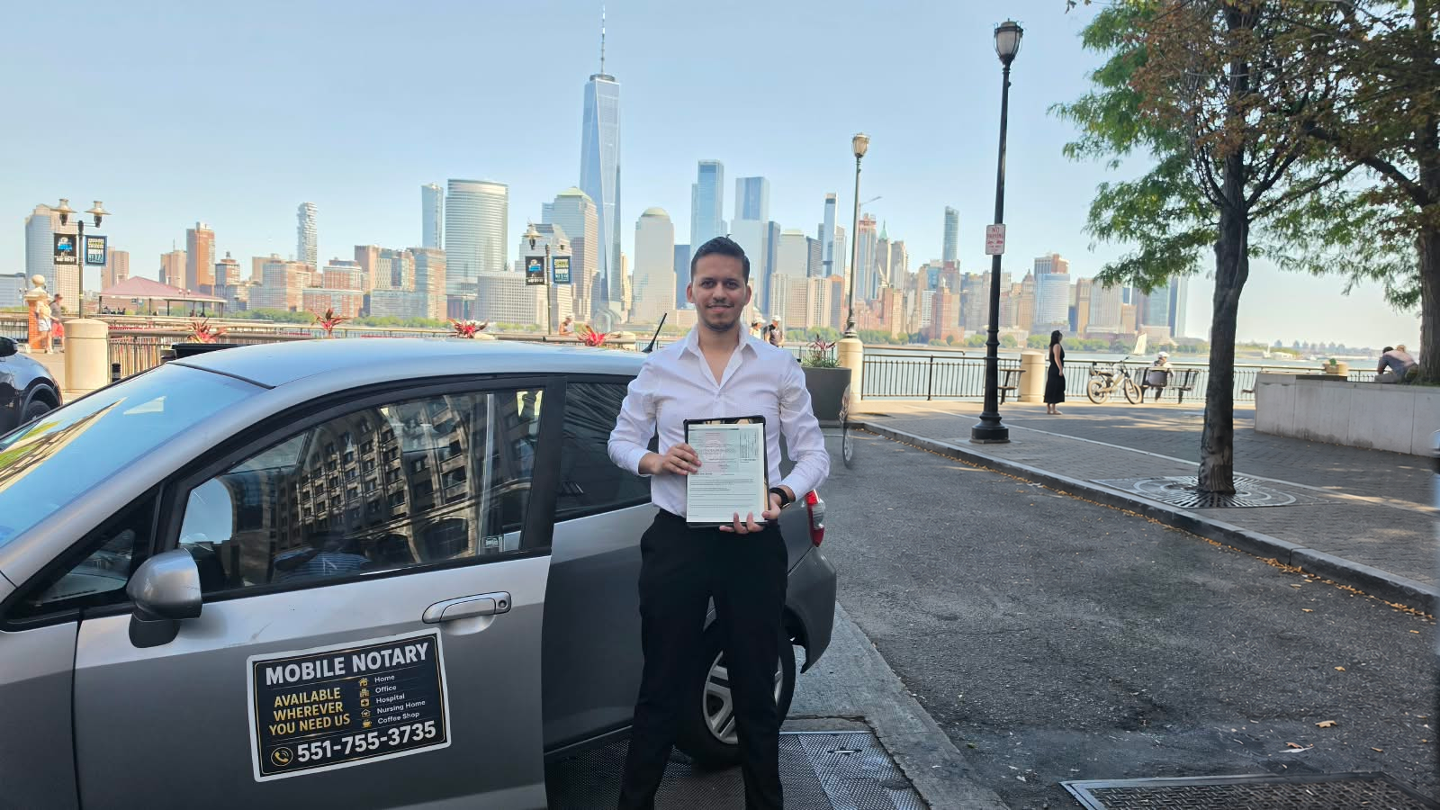 Manef beside his mobile notary vehicle on the Hudson waterfront